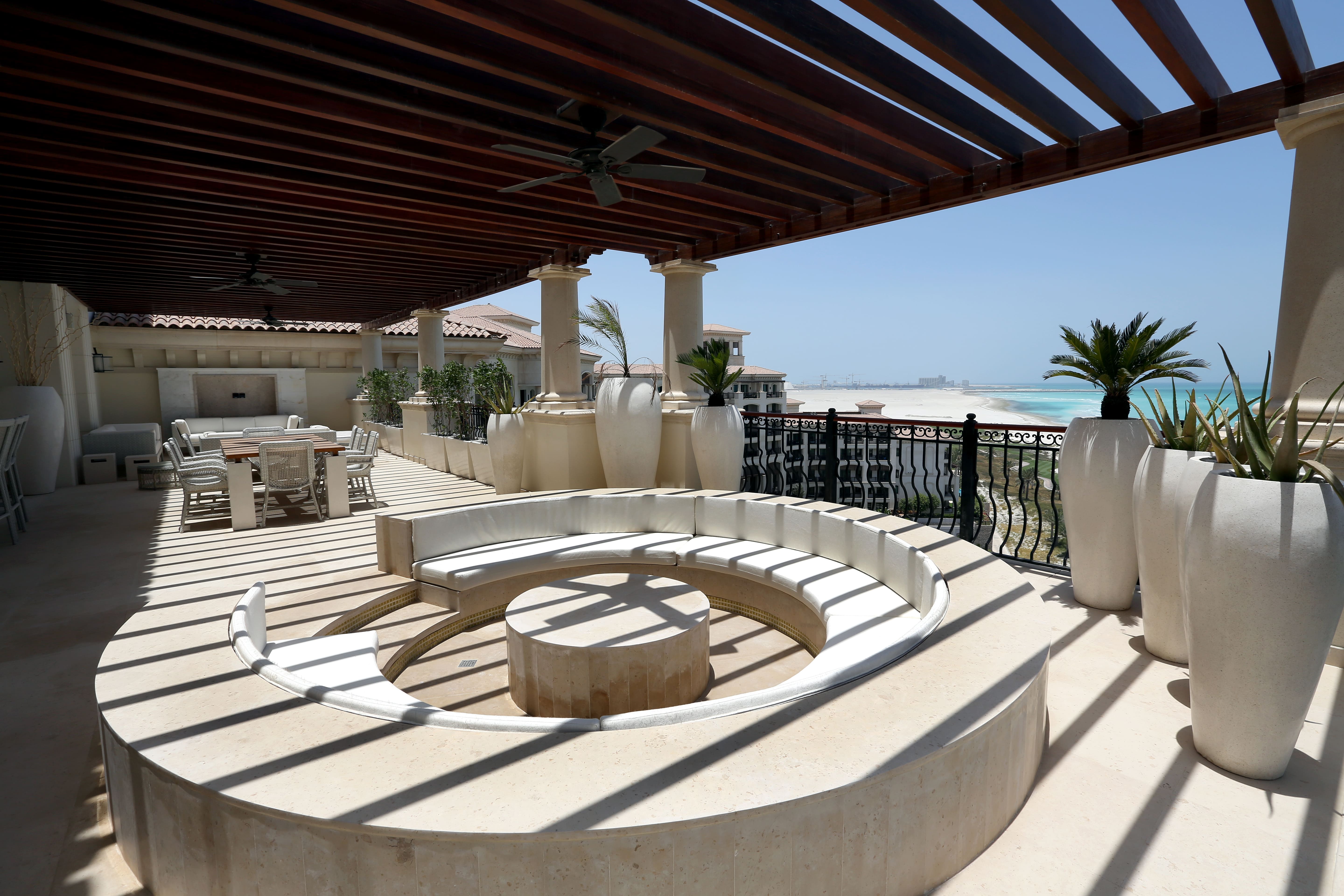 Outdoor patio pergola with giant stone planters and stone seting area