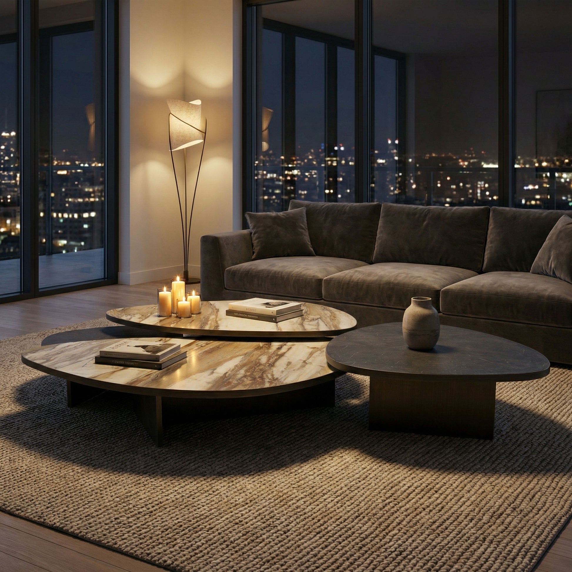 Aurelia marble coffee tables in the middle of modern living room with a sectional sofa, and cityscape view.