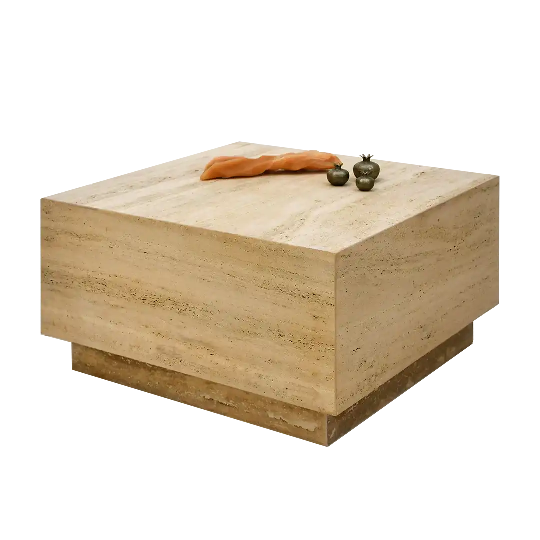 Hampton beige travertine coffee table with decorative items on a white background