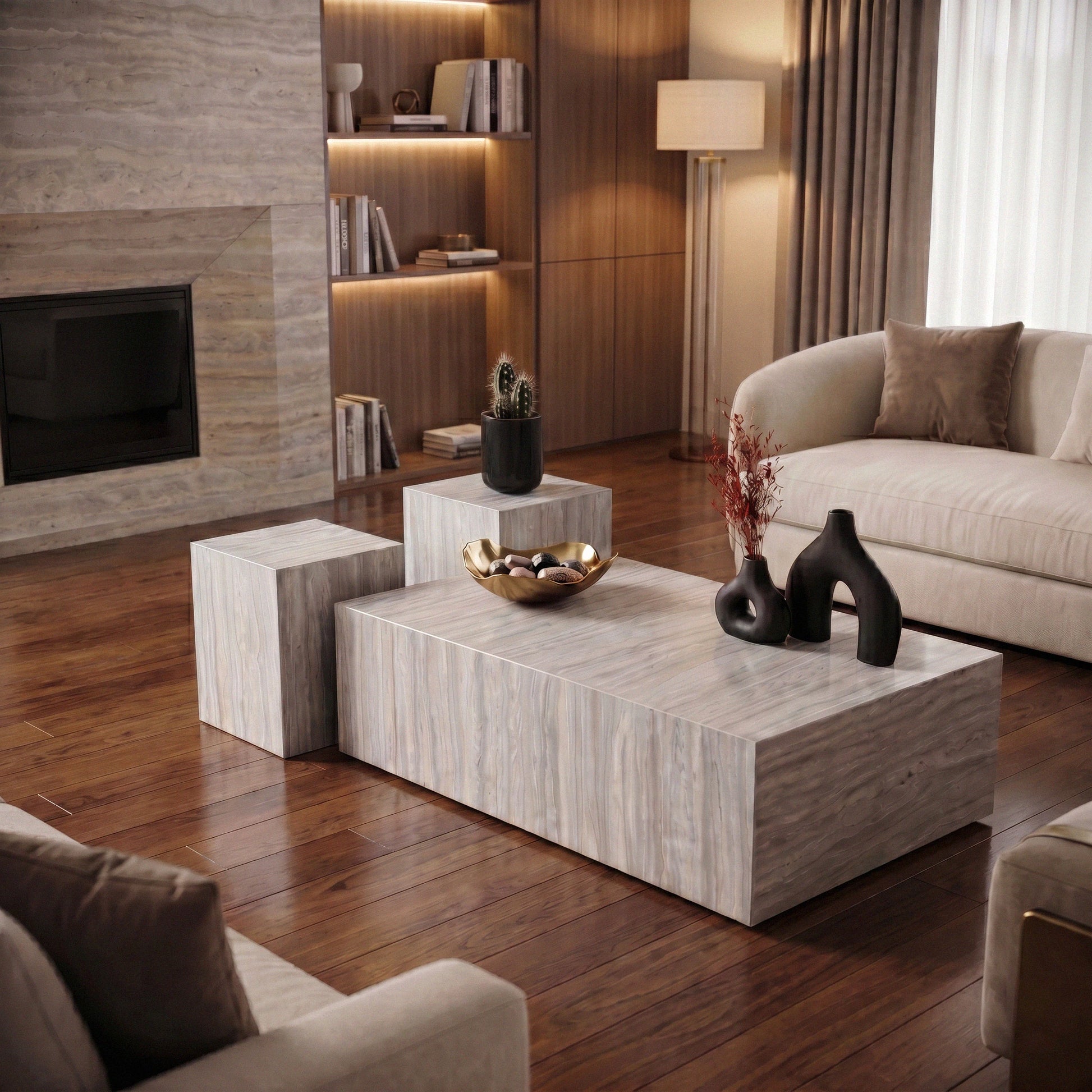 Hugo coffee tables; a set of gray marble coffee tables with decorative items on a parquet flooring in modern living room
