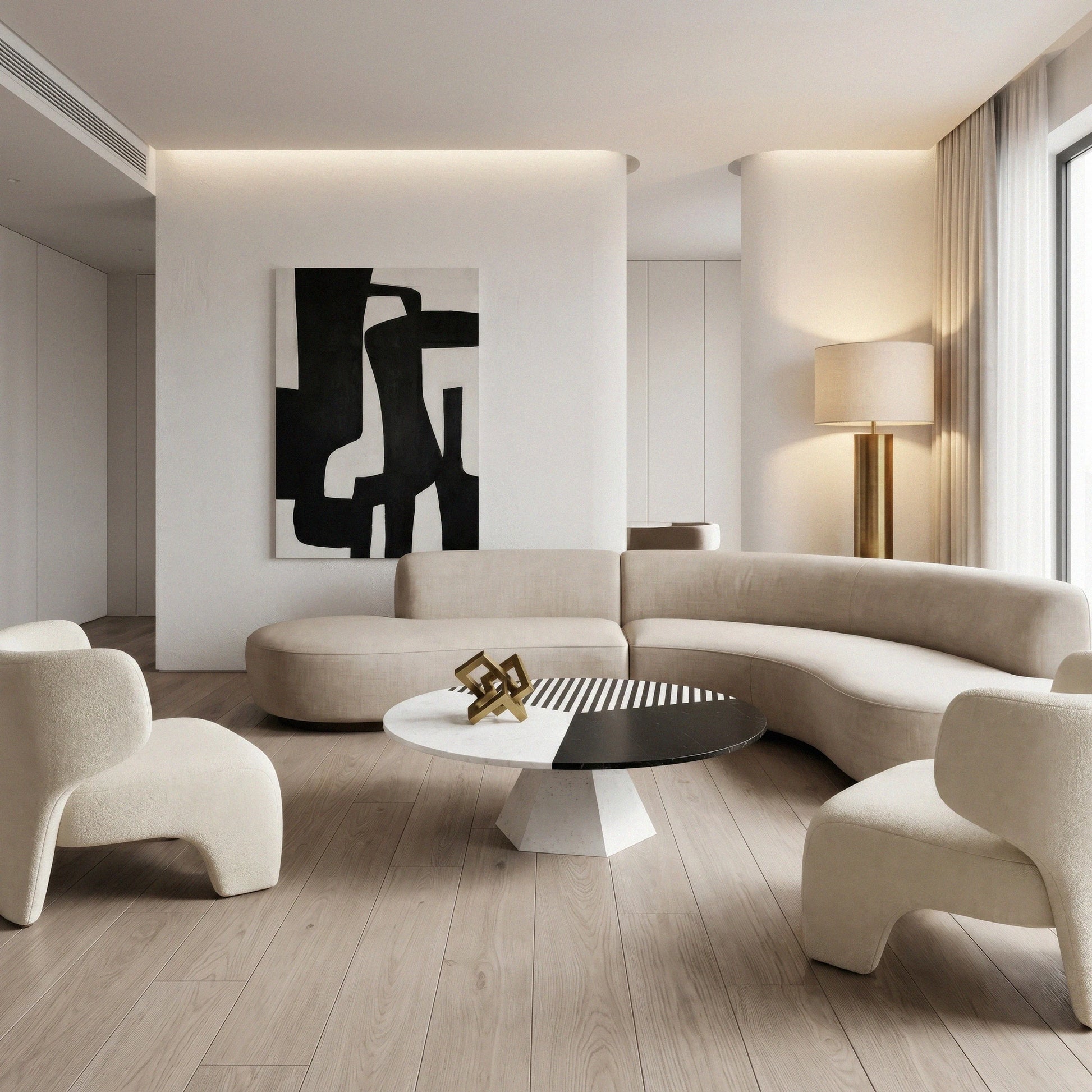 Jose round marble coffee table from Marbeya Charm in the middle of living room with curved ivory colored sofas and abstract paint on the wall