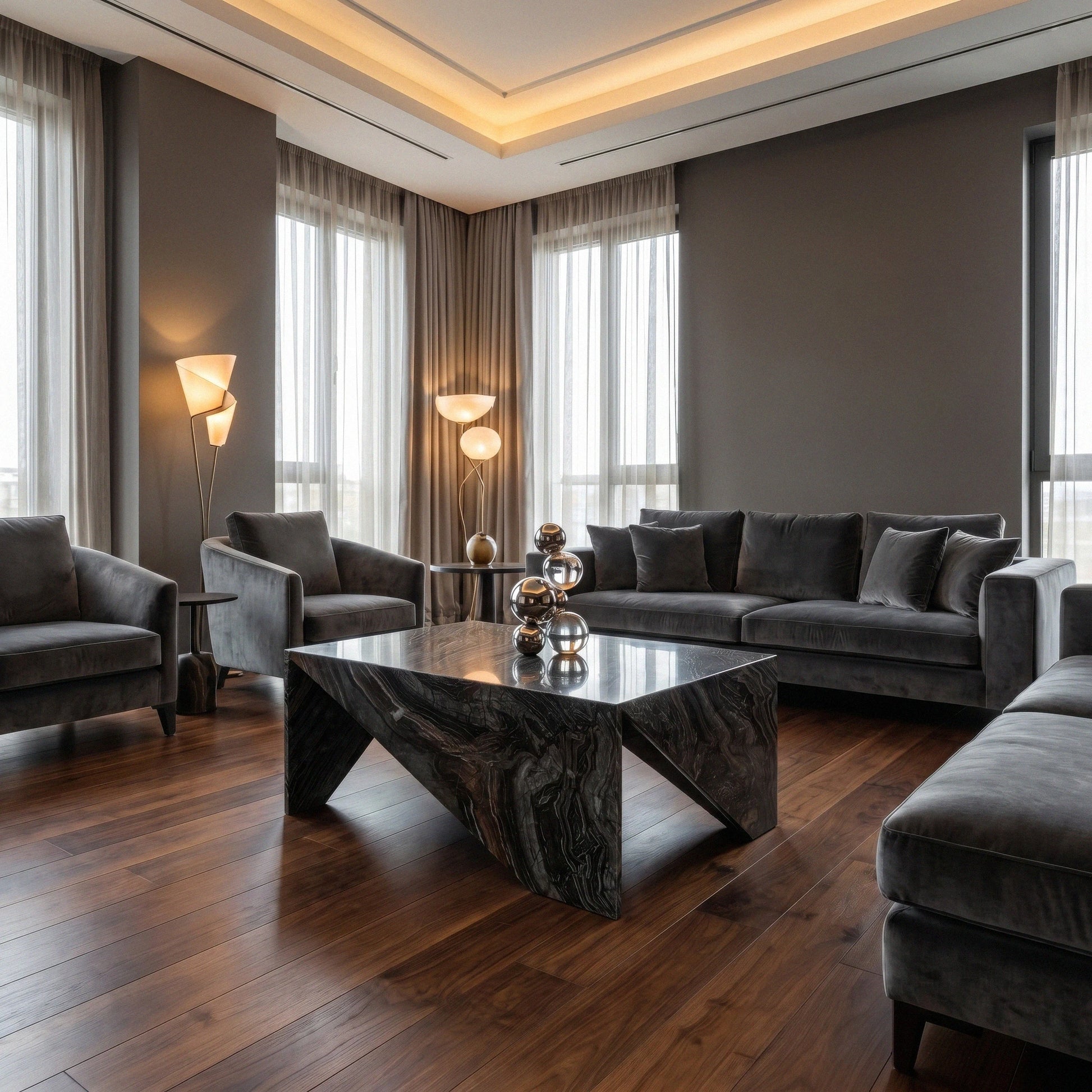 Origami Black Marble Coffee Table from Marbeya Charm in a modern living room with dark gray sofas and wooden floor
