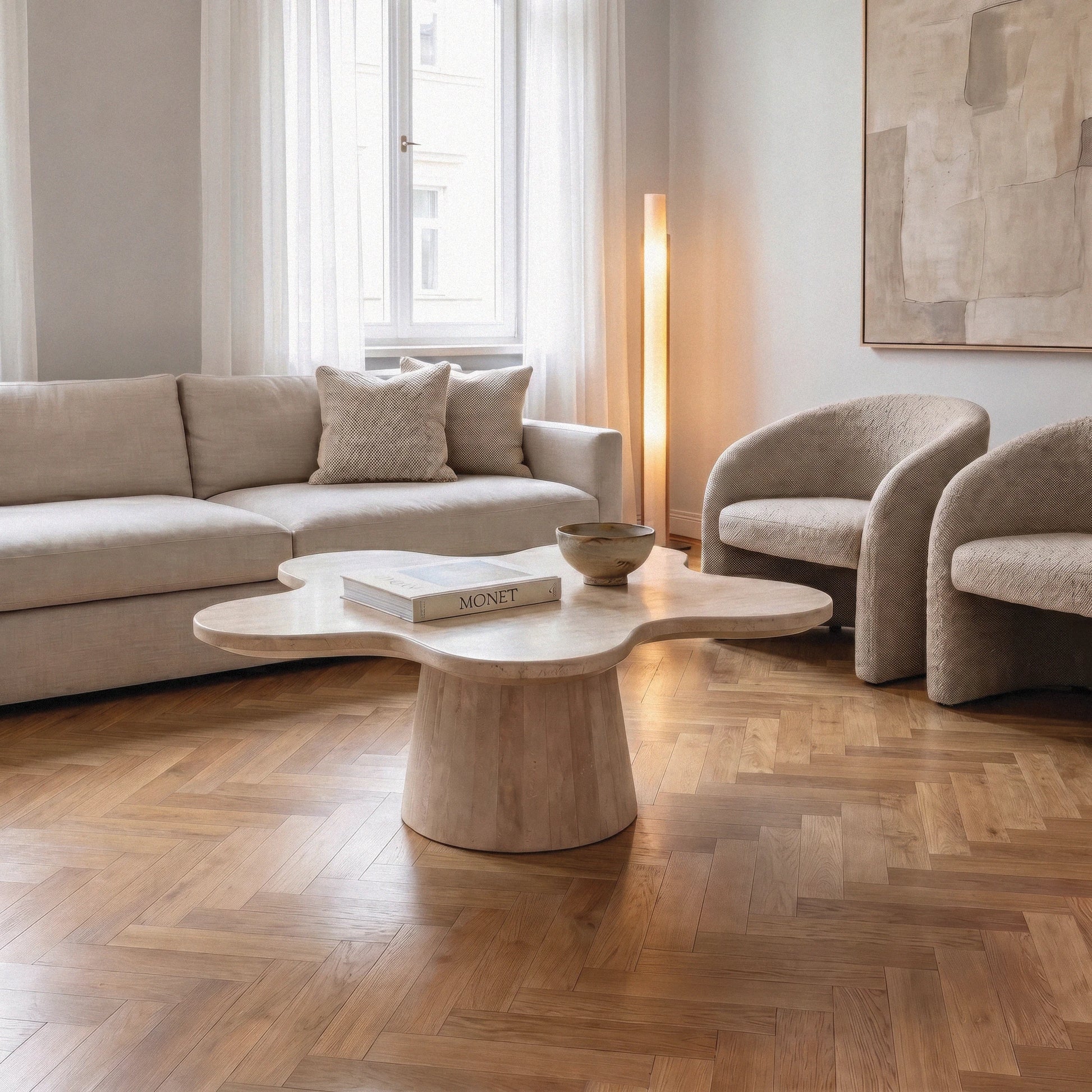 Petalo Travertine Coffee Table in a modern living room with parquet flooring and beige sofas 