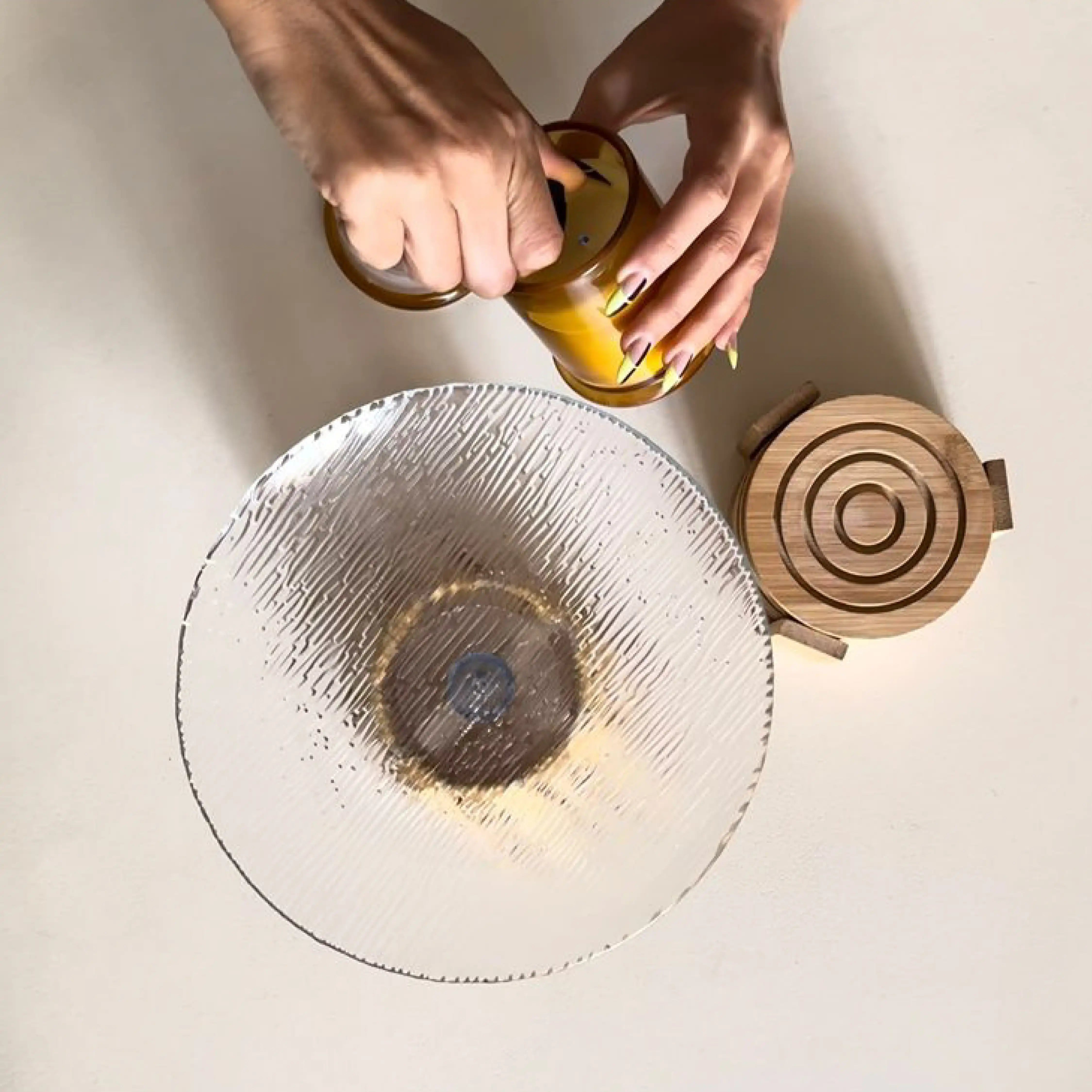 Hands of a girl lighting candles on TERRA MICROCEMENT COFFEE TABLE - Marbeya Charm